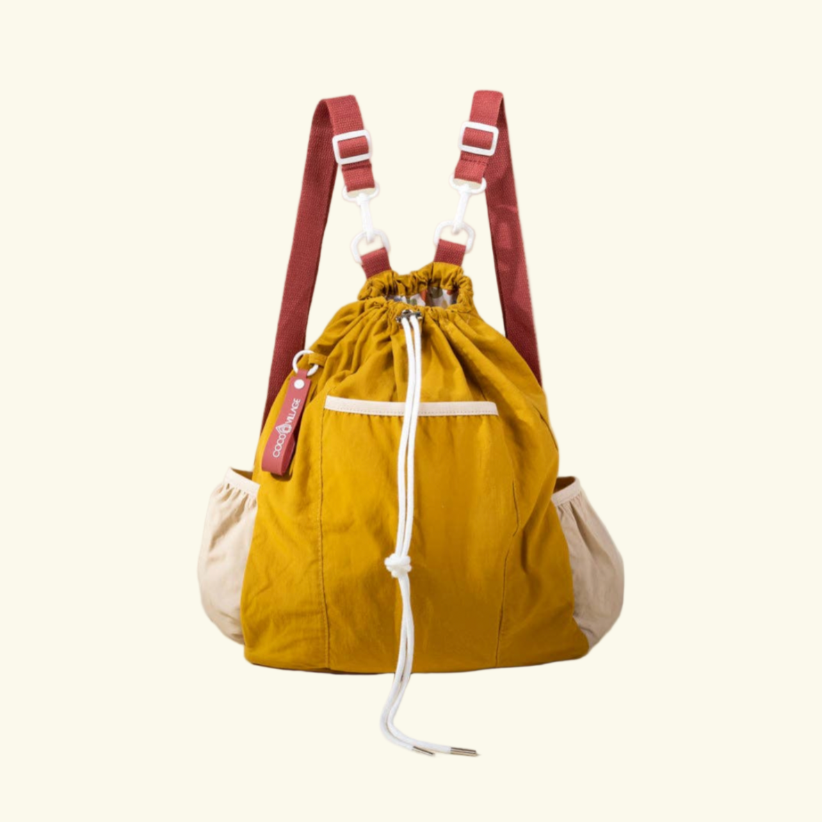 Yellow drawstring bag with red straps on a beige background