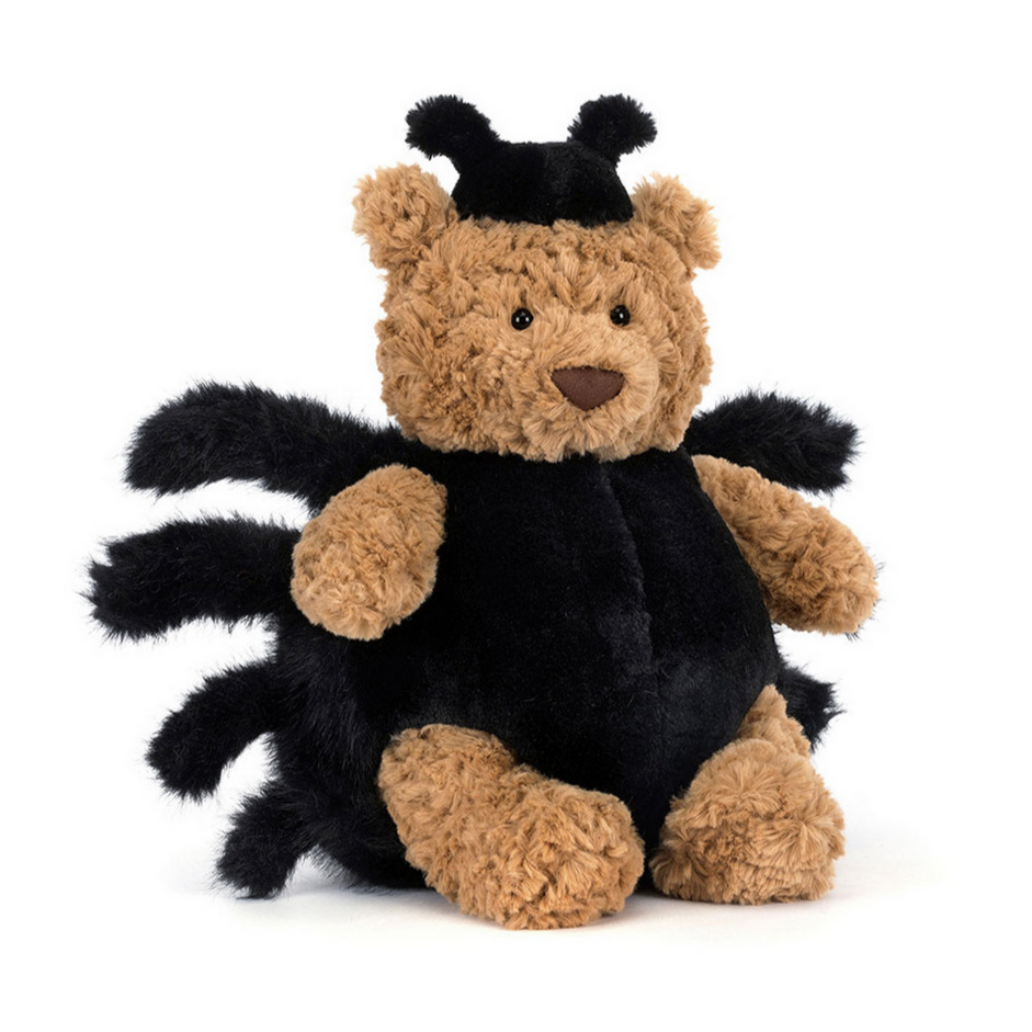 Stuffed bear toy dressed as a spider on a white background