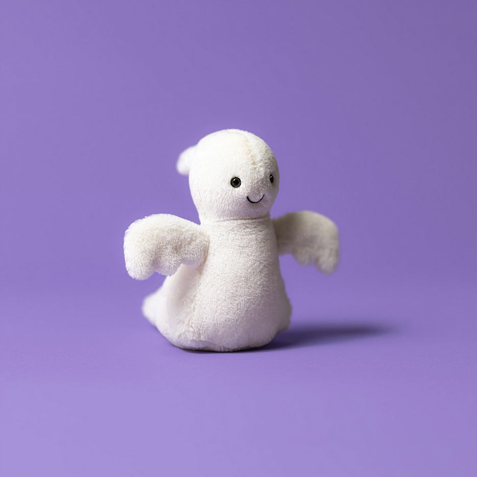 White plush ghost toy on a purple background