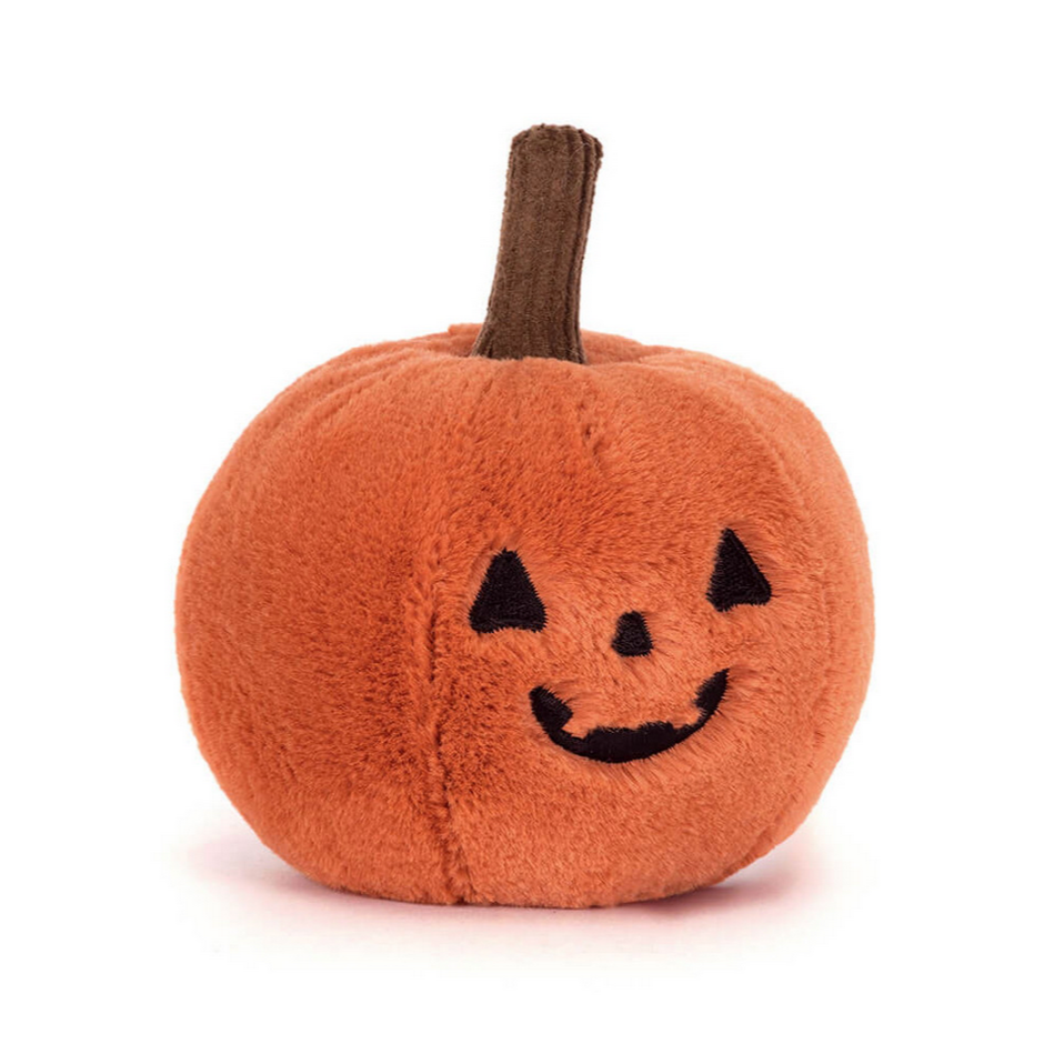 Plush pumpkin toy with a smiling face on a white background
