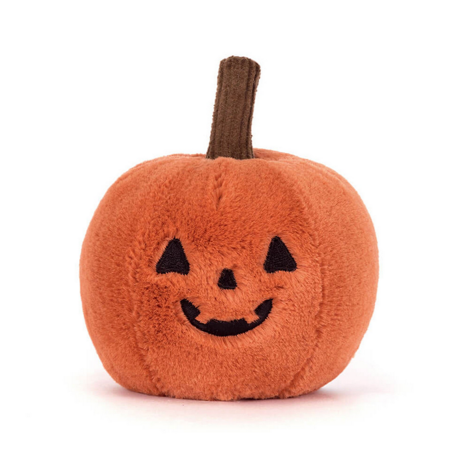 Plush pumpkin toy with a smiling face on a white background