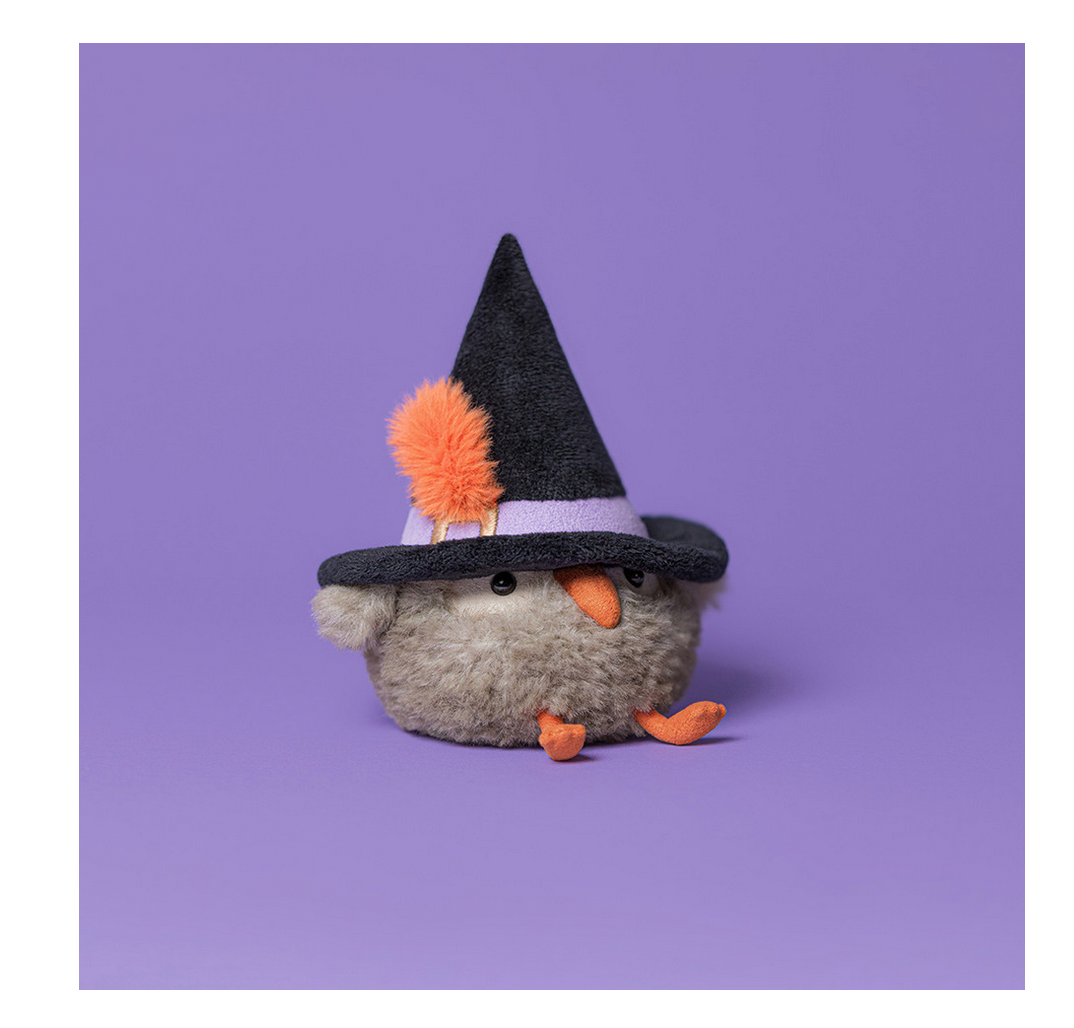 Small plush toy with a witch hat on a purple background