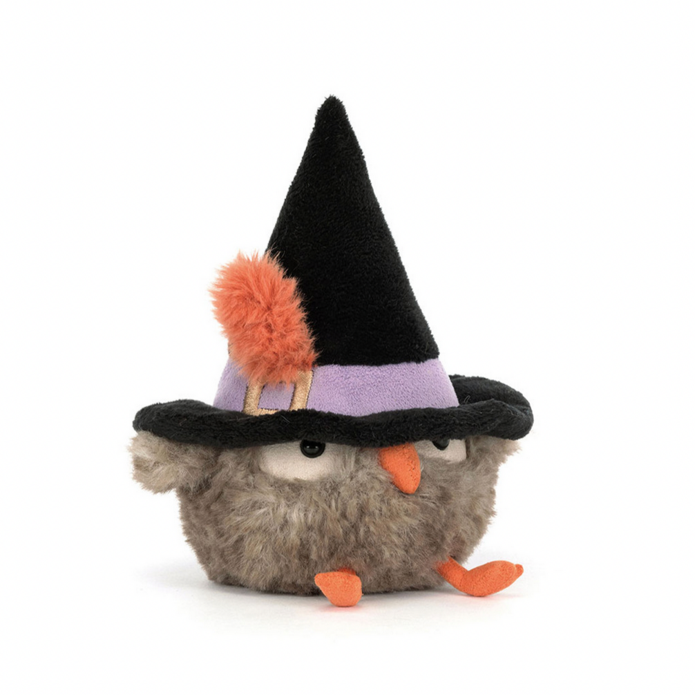 Plush toy owl wearing a witch hat on a white background