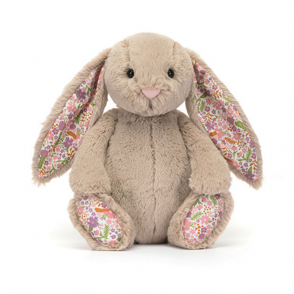 Floral-patterned plush bunny toy on a white background