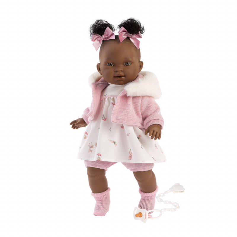 Doll in a pink outfit with a white background
