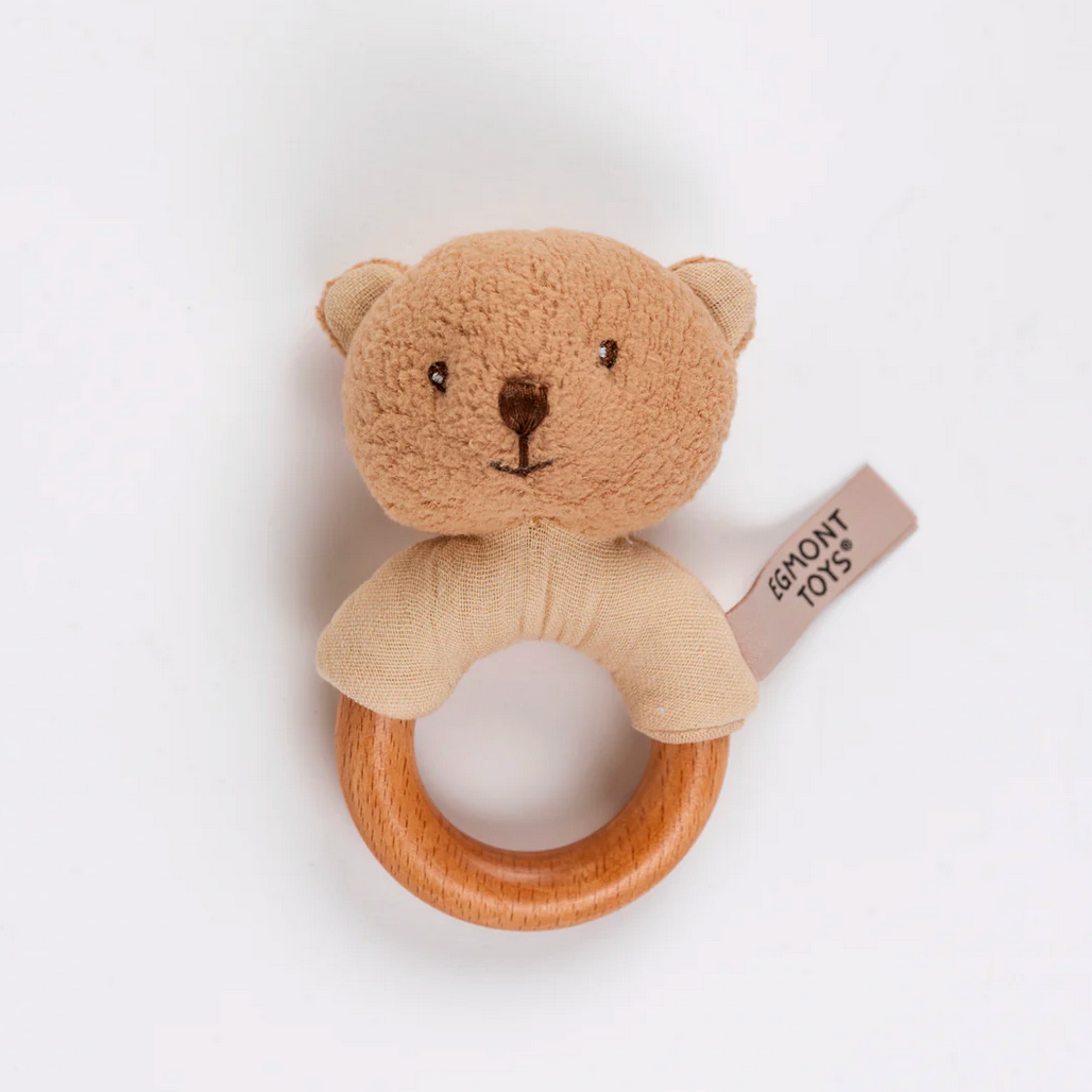 Teddy bear-shaped wooden rattle with Eghmont Toys tag on a white background