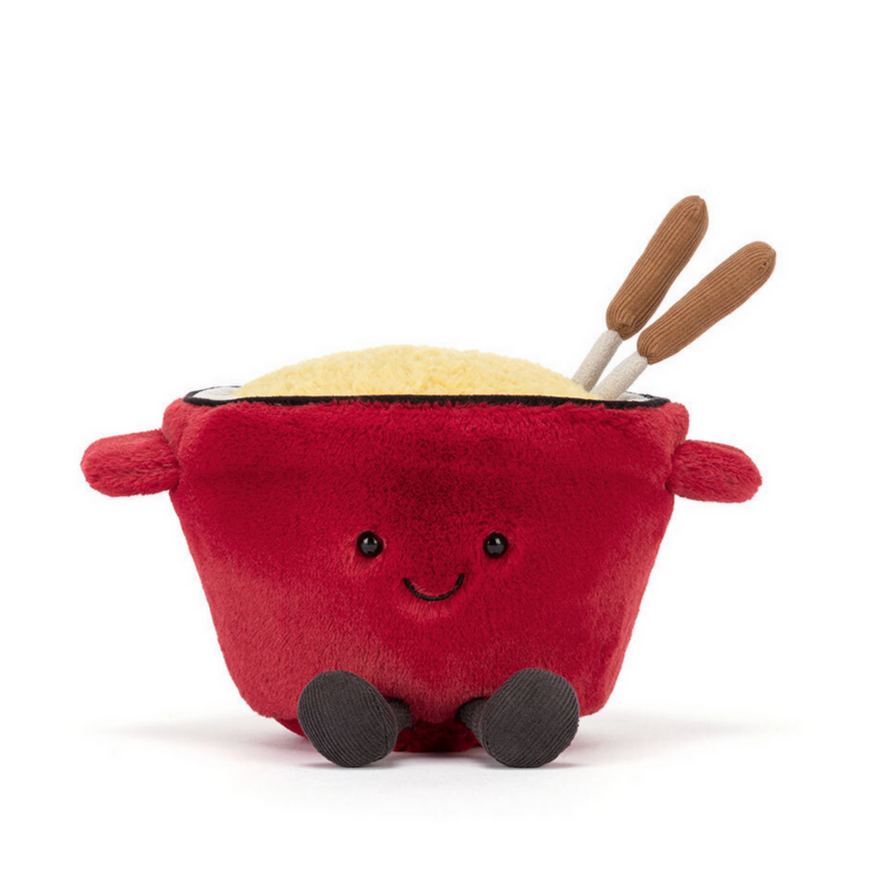 Plush toy resembling a red bowl with a face, skewers, and cheese on a white background
