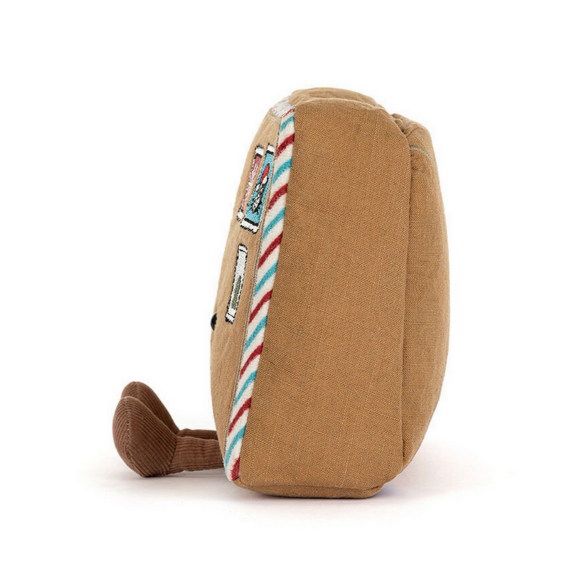 Brown plush toy with a striped ribbon on a white background
