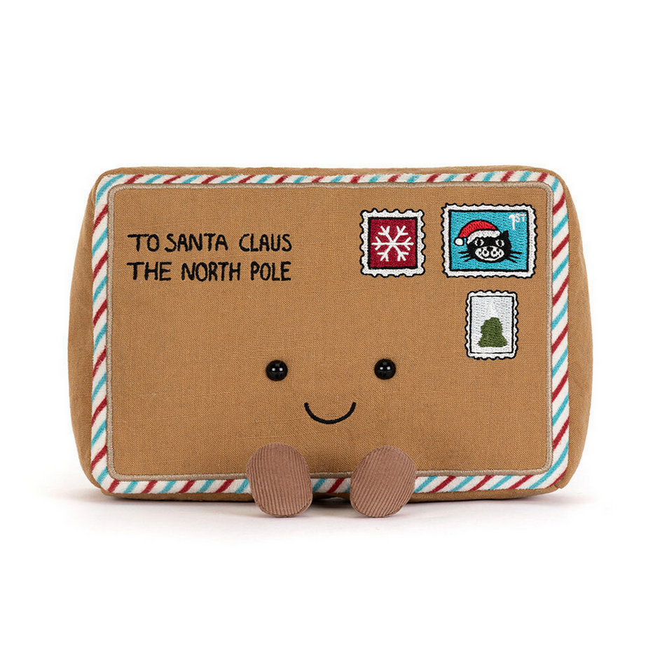 Plush toy resembling a letter to Santa Claus with stamps on a white background