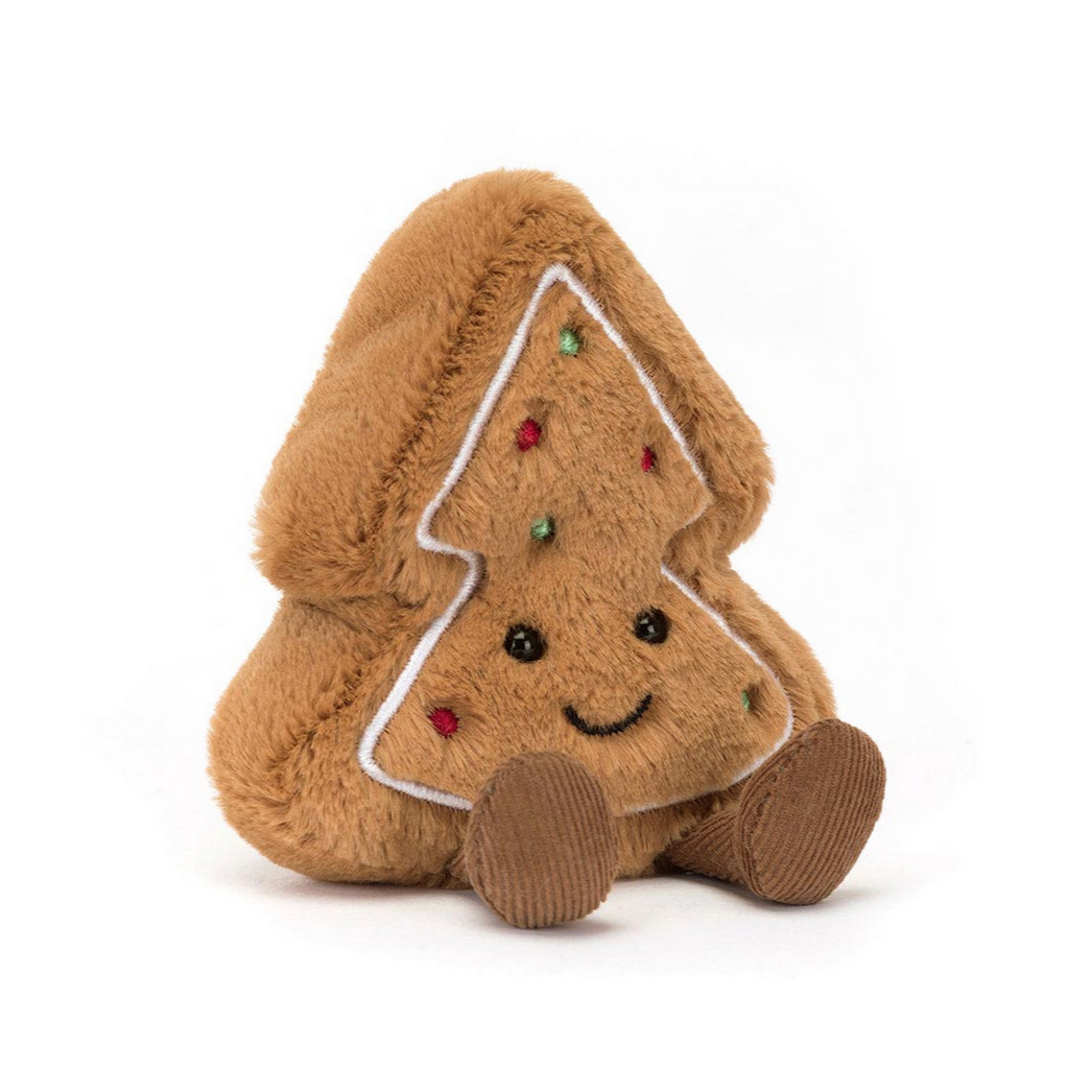Plush gingerbread tree toy with a smiling face on a white background
