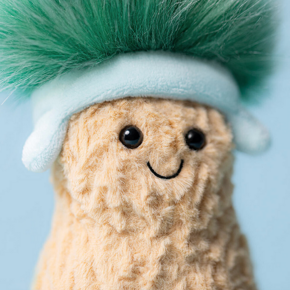 Plush toy with a green top hat and white band on a light blue background