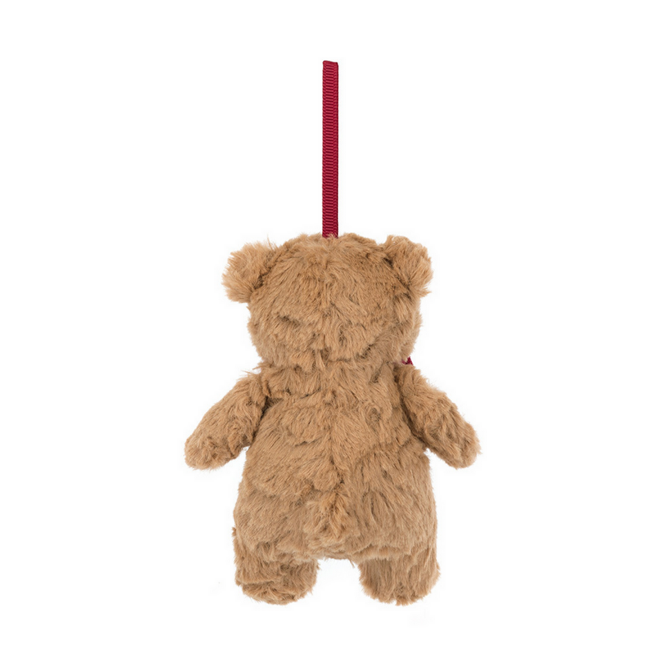 Brown teddy bear hanging from a red string on a white background