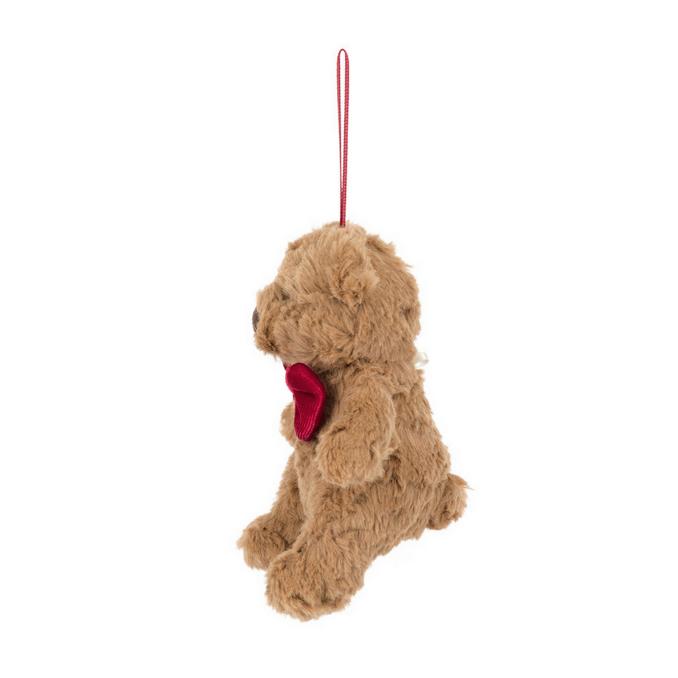 Plush teddy bear with a red heart on a white background