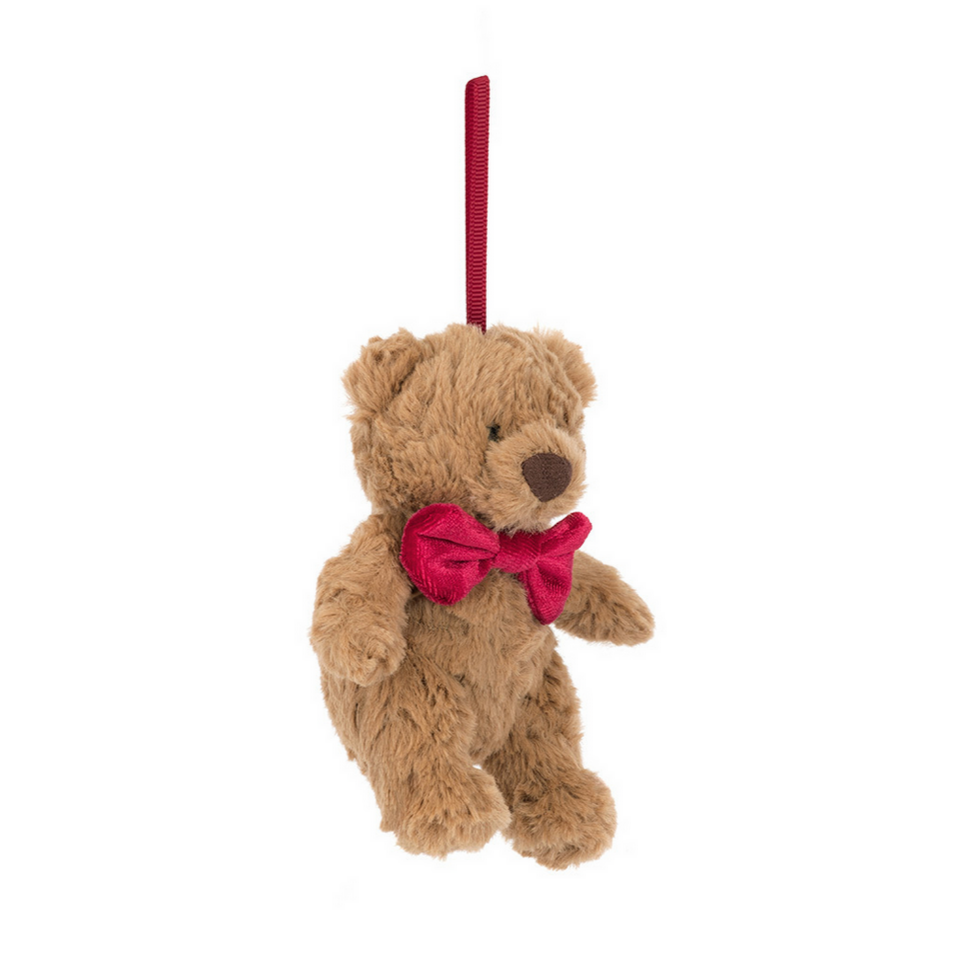 Plush teddy bear with a red bow tie on a white background