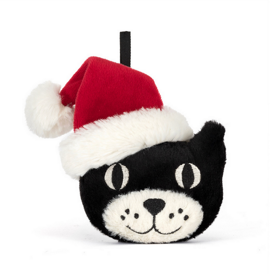 Black and white plush toy with a Santa hat on a white background