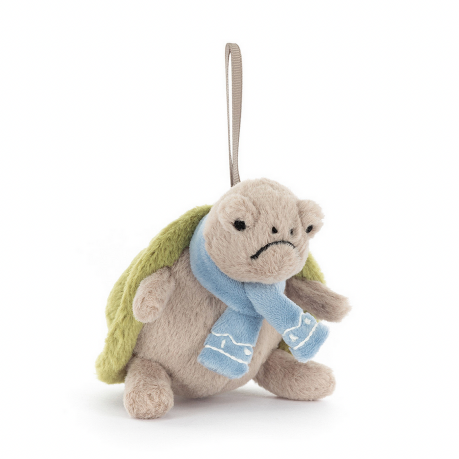 Plush turtle toy with a blue scarf on a white background