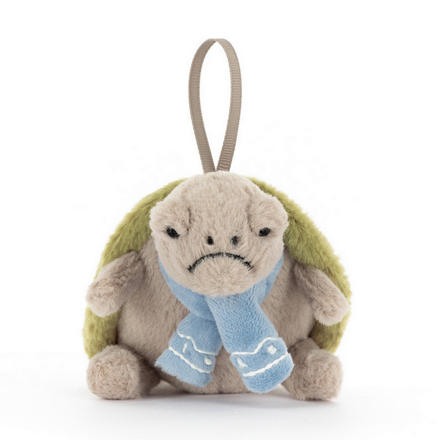 Plush turtle toy with a blue scarf on a white background