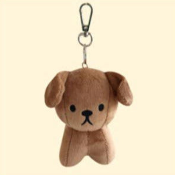 Plush dog keychain with a clip on a beige background