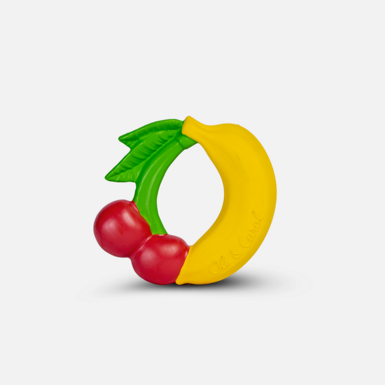 Toy ring with banana, cherries, and green leaf on a white background