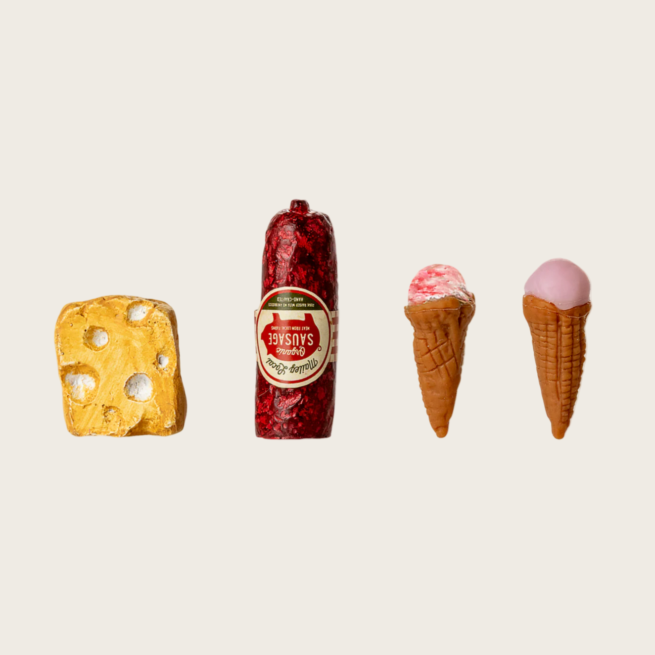 Collection of ice cream cones and a sausage on a beige background