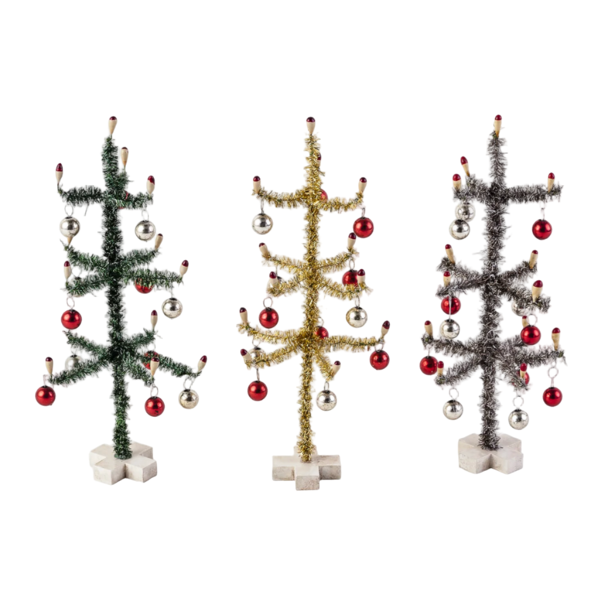 Three small Christmas trees with ornaments on a white background