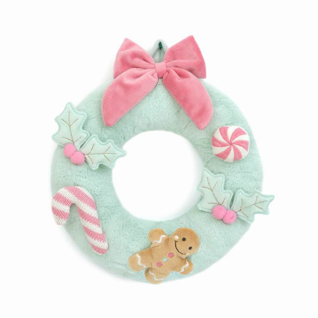 Decorative wreath with a pink bow, candy cane, gingerbread man, and cookies on a white background