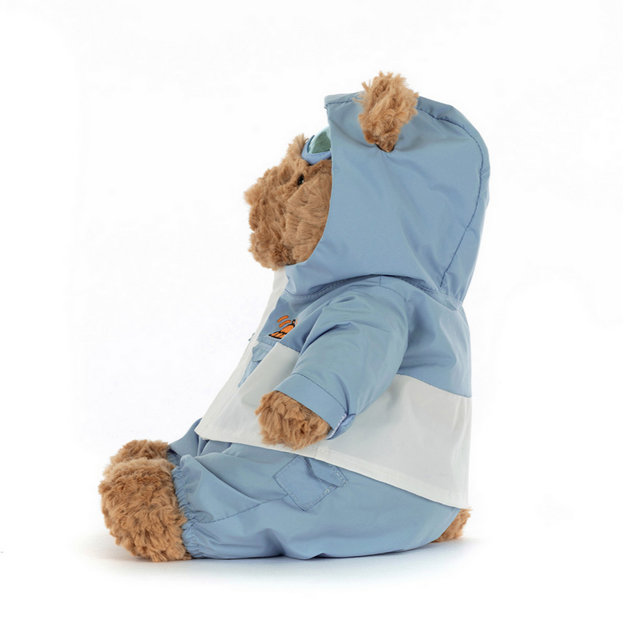 Teddy bear wearing a blue and white striped hoodie on a white background