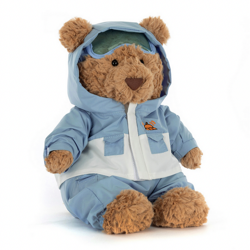 Teddy bear wearing a blue outfit with a hood on a white background