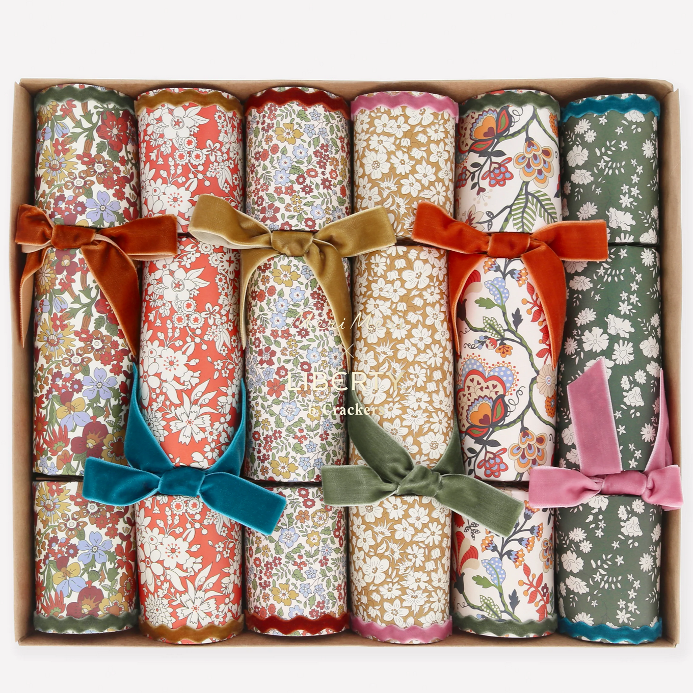 Set of floral cracker boxes with colorful bows in a cardboard box.