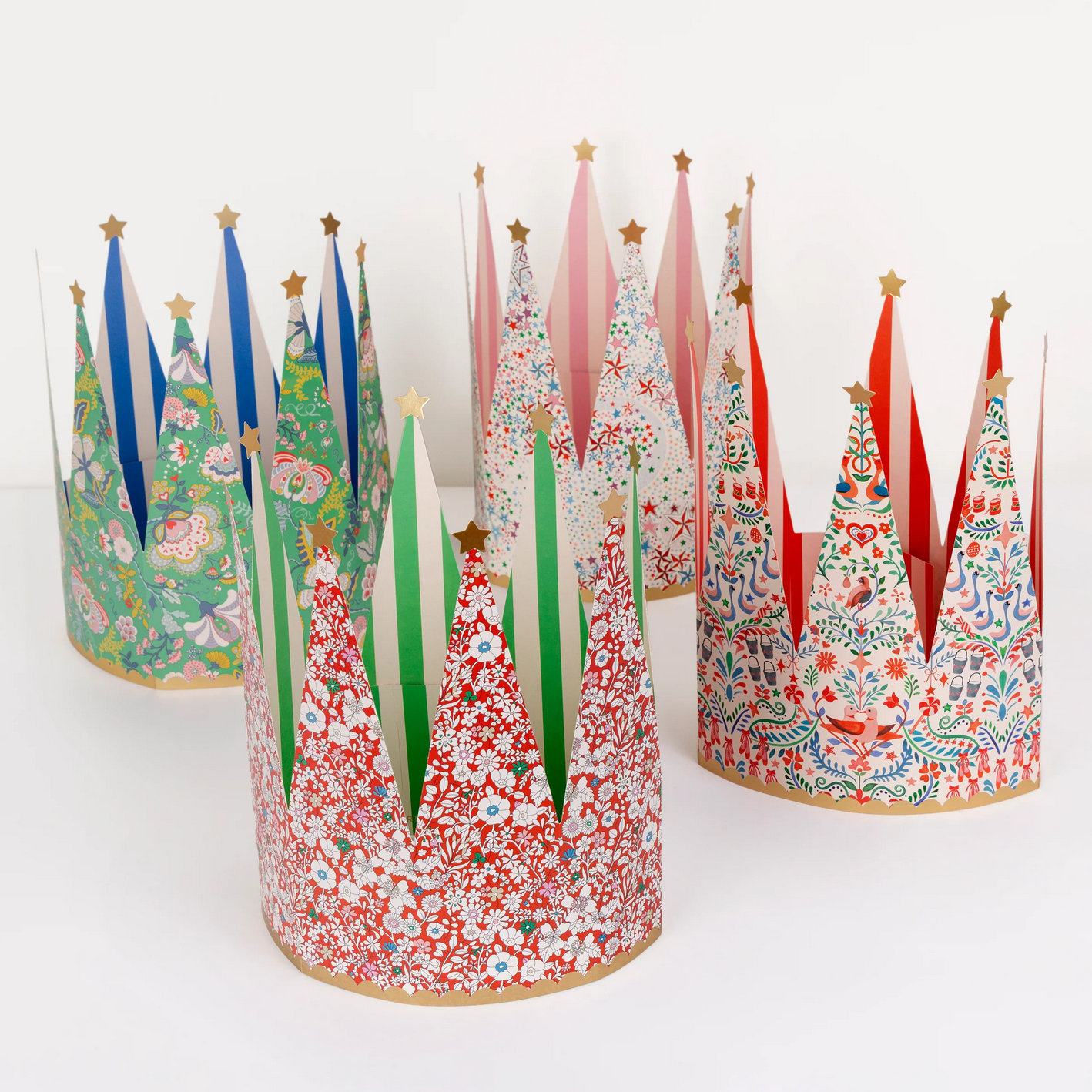 Colorful paper tree hats with floral patterns on a white background
