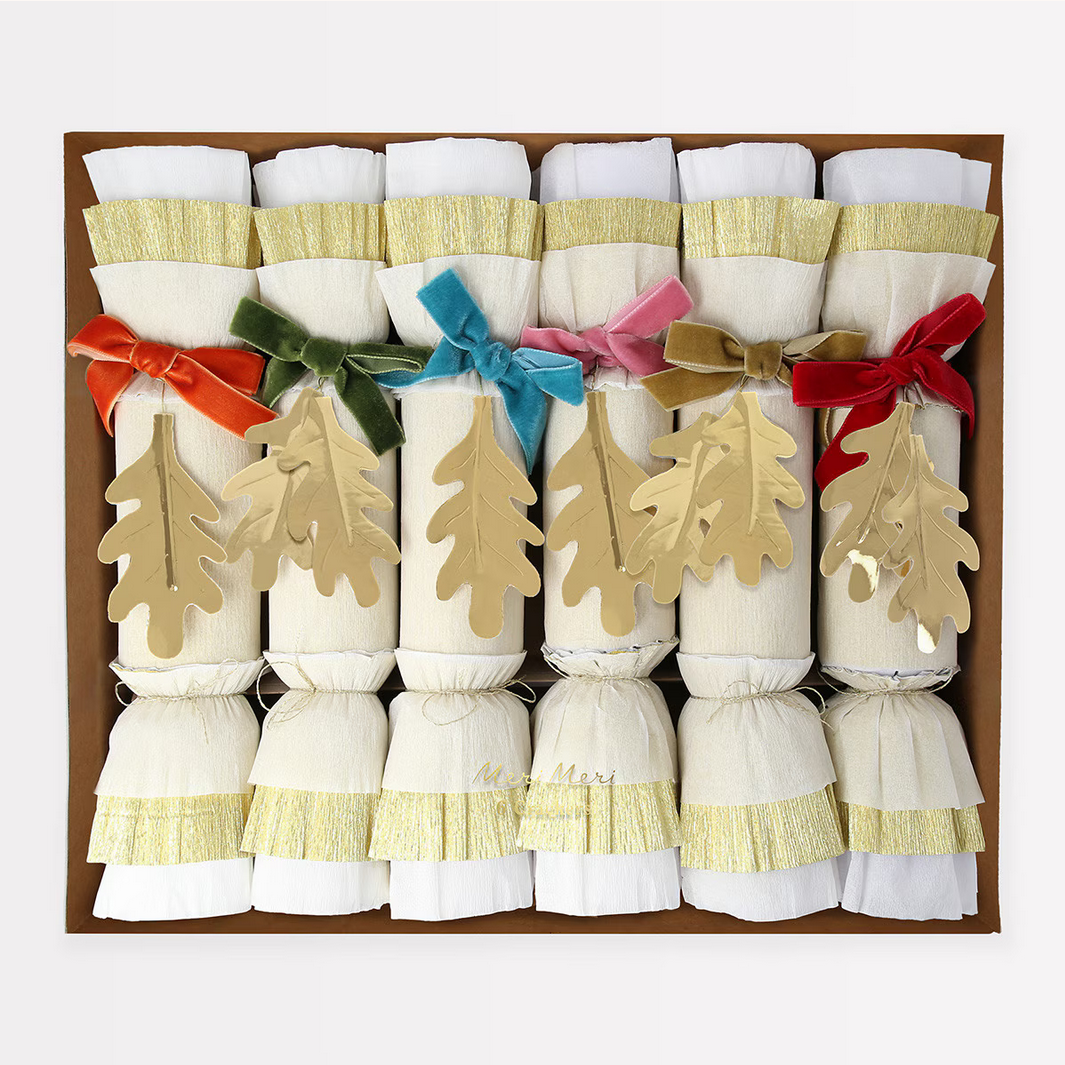 Decorative crackers with colorful ribbons and tree-shaped decorations in a box.