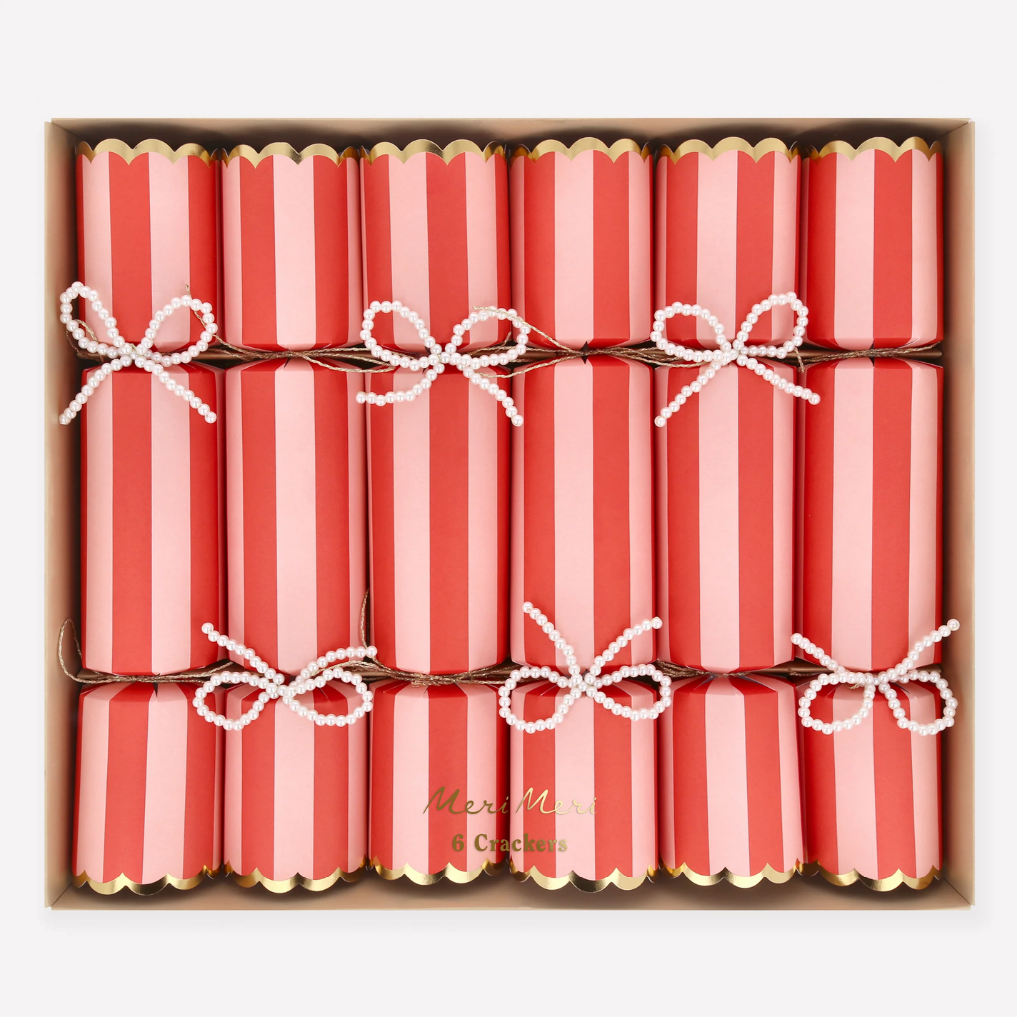 Box of red and pink striped crackers with white bows in a decorative box.