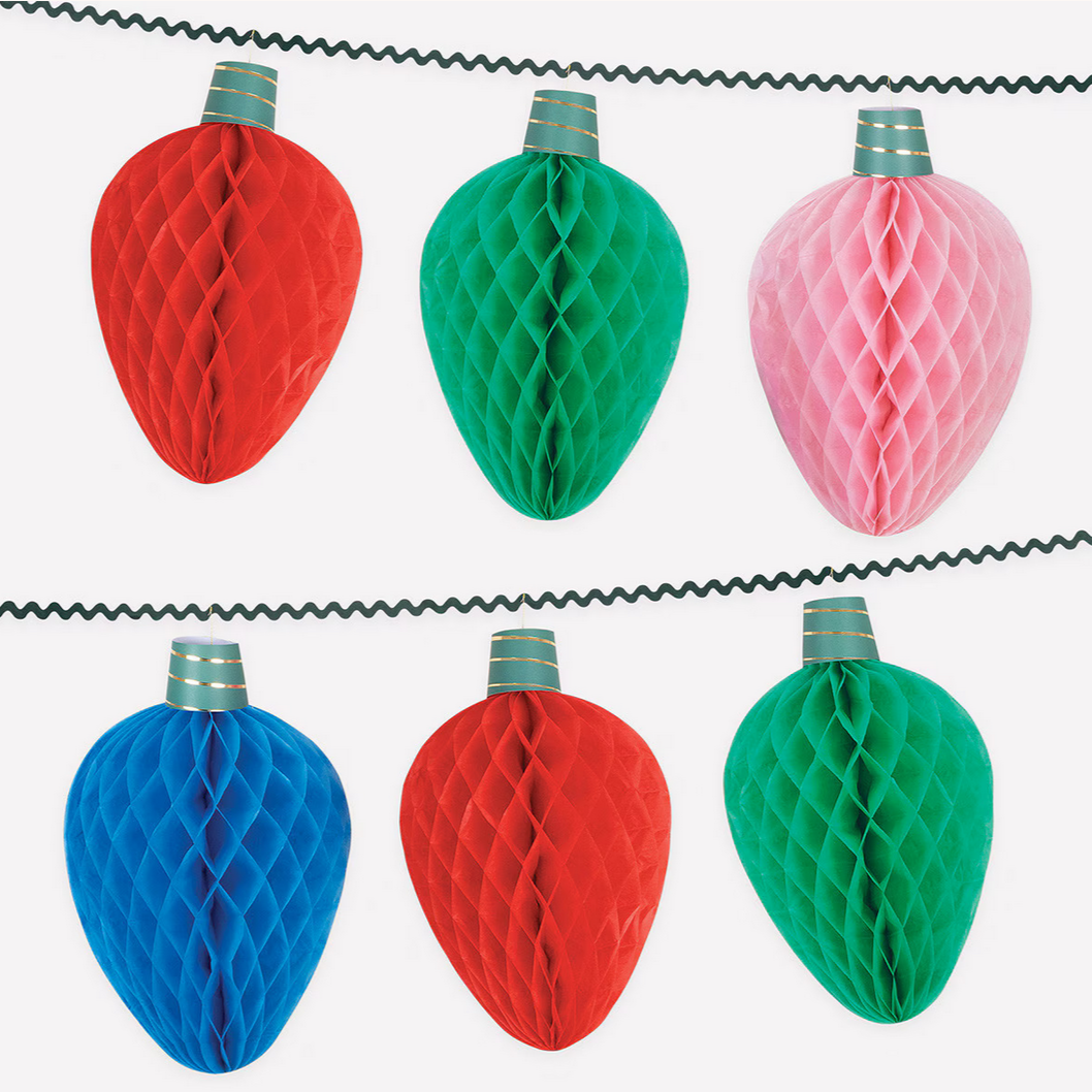 Decorative string lights with red, green, and pink honeycomb designs on a white background.