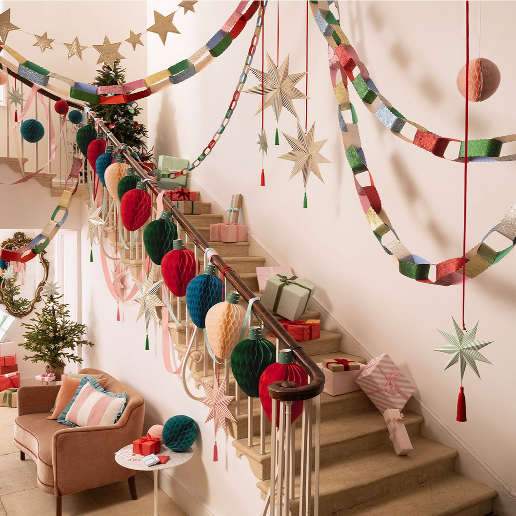 Decorative Christmas garlands and ornaments on a staircase with festive decor.