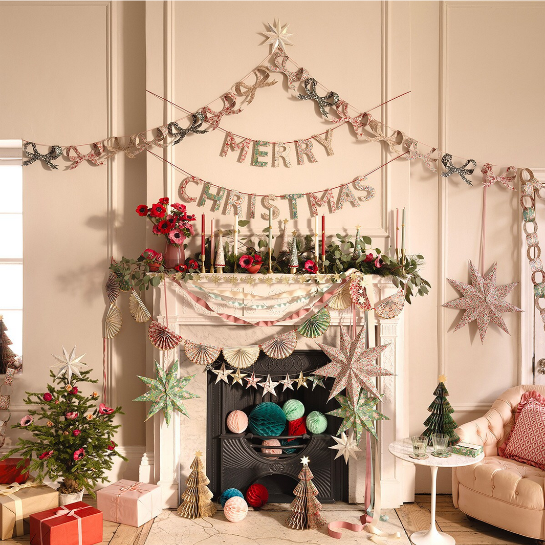 Decorated living room with Christmas decorations, including a 'Merry Christmas' banner and festive items.