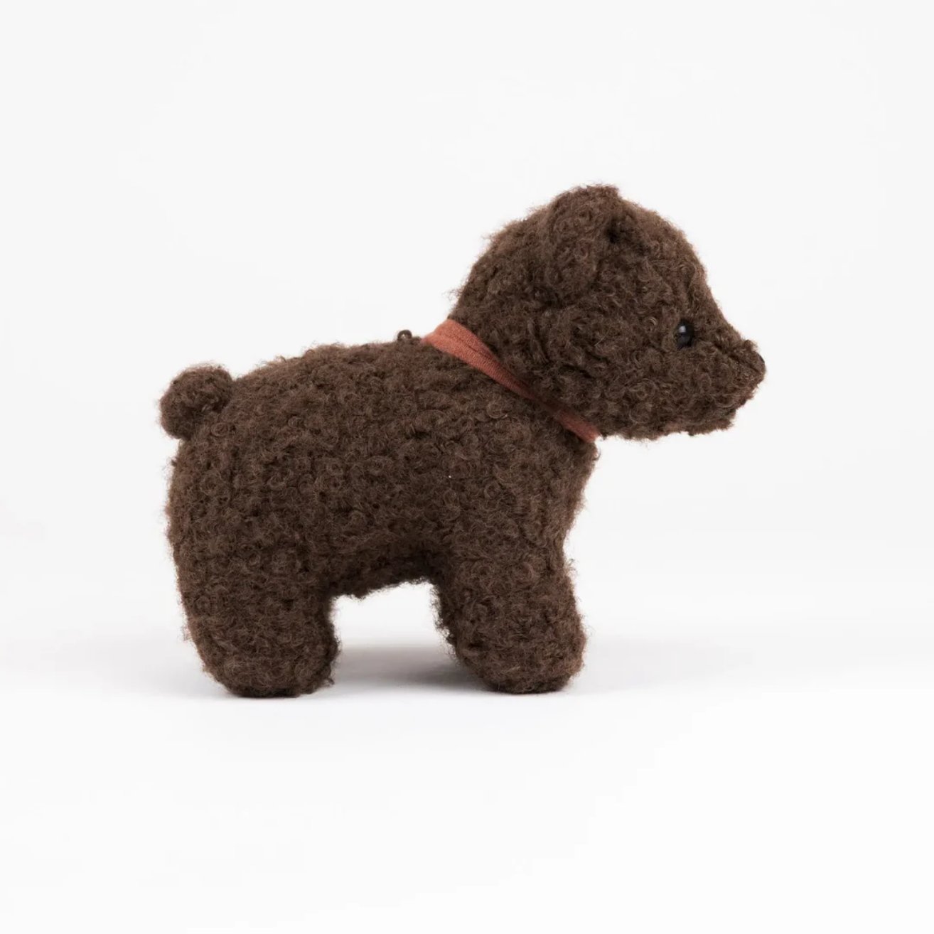 Small brown dog toy on a white background