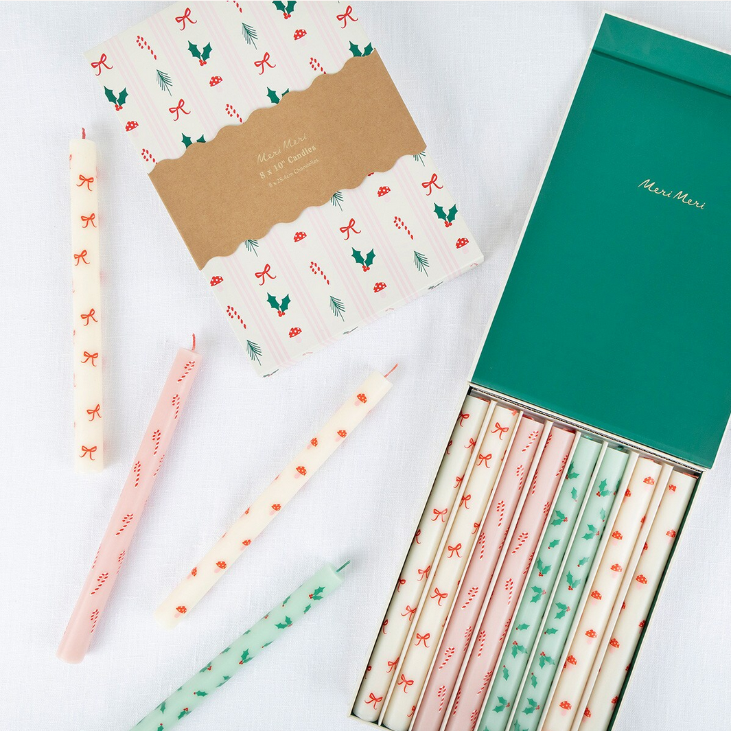 Set of decorative pencils and stationery items with festive designs on a white background