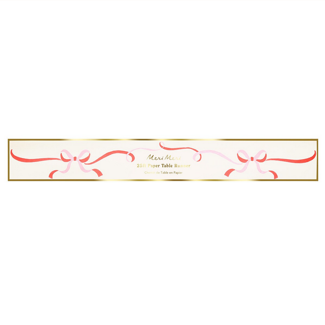 Decorative paper table runner with pink bows on a white background