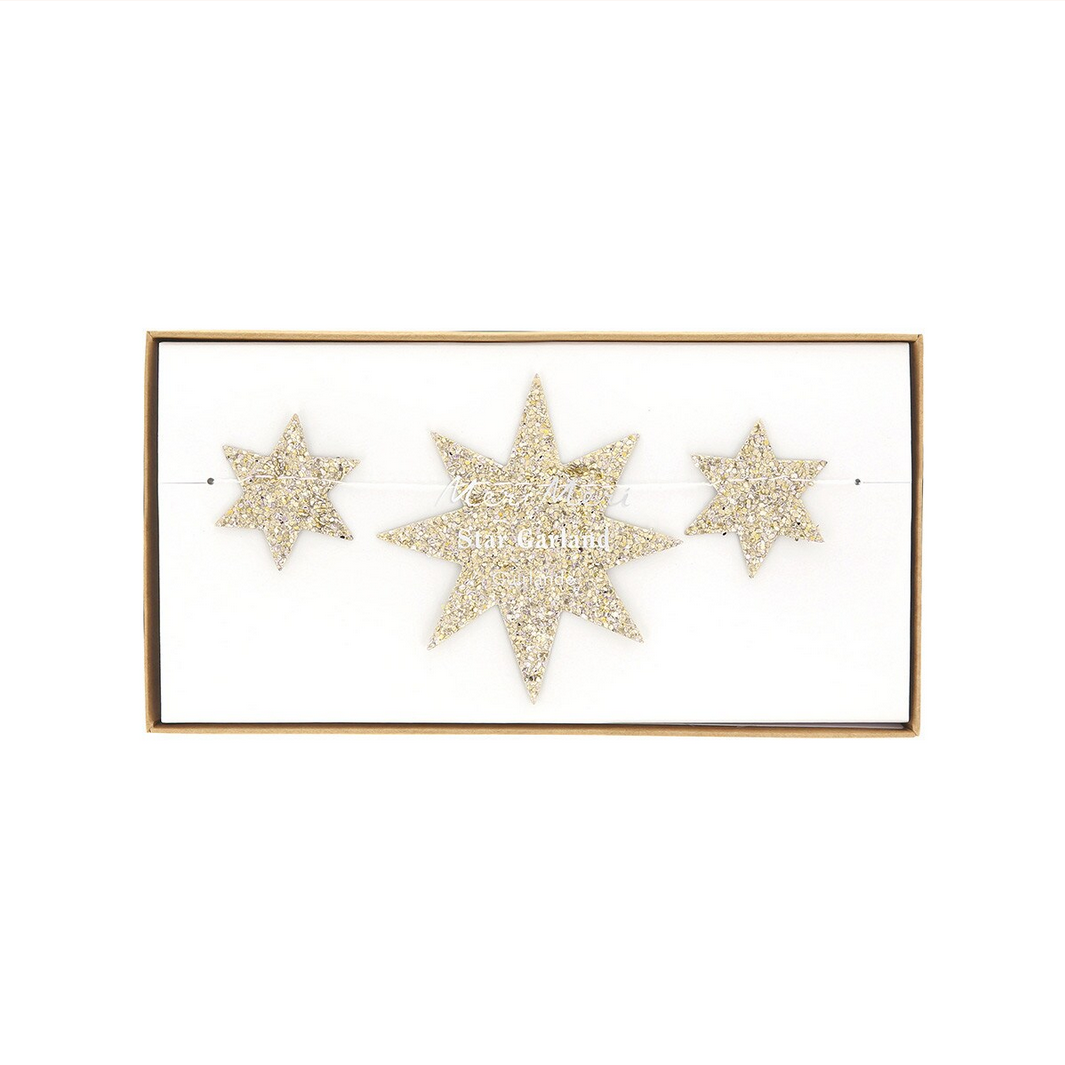 Star-shaped earrings with glittery texture on a white background