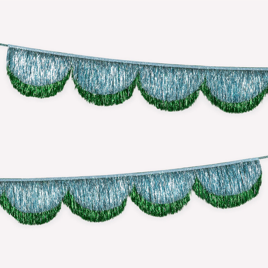 Decorative metallic fringe trim with green edges on a white background
