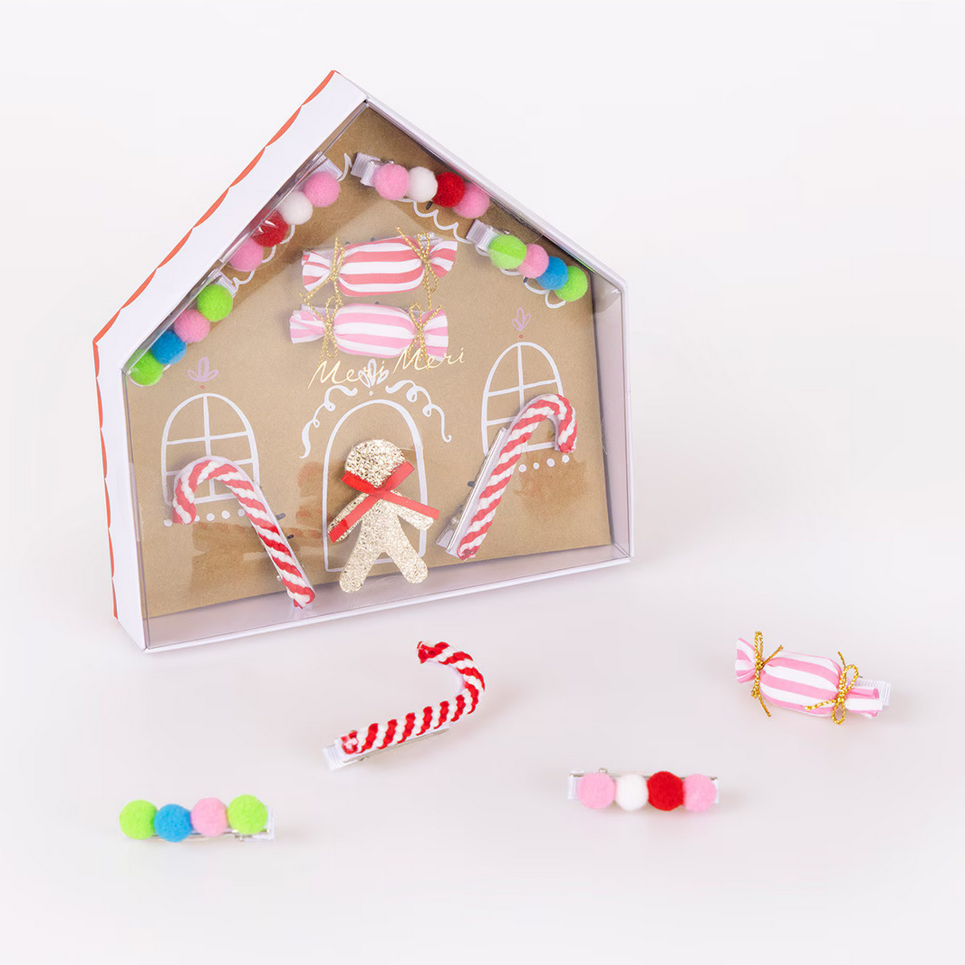 Decorative gingerbread house kit with candy-themed decorations on a white background