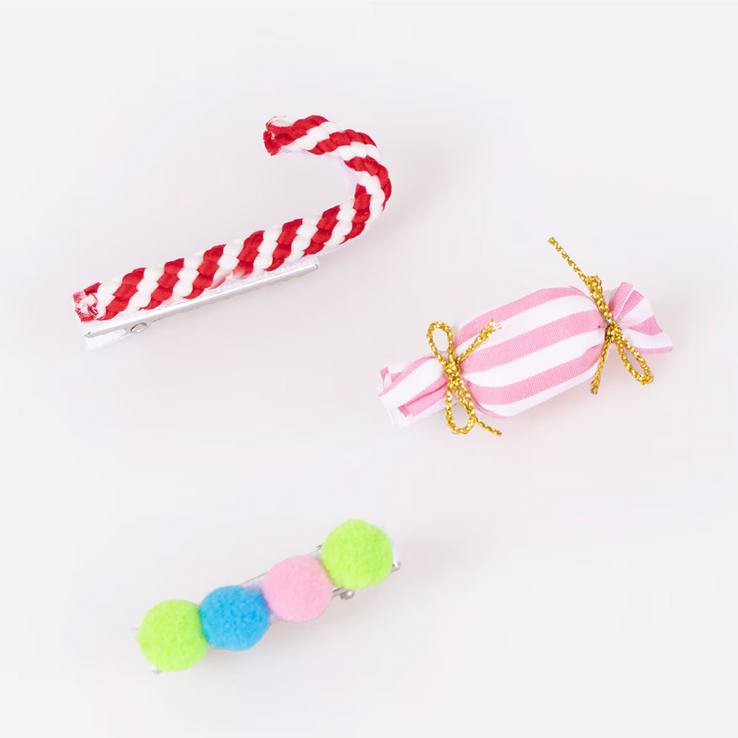 Three decorative candy-themed hair clips on a white background