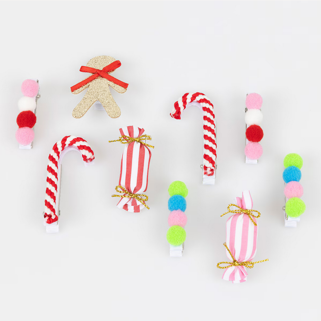 Decorative Christmas ornaments including candy canes, gingerbread men, and other festive items on a white background.
