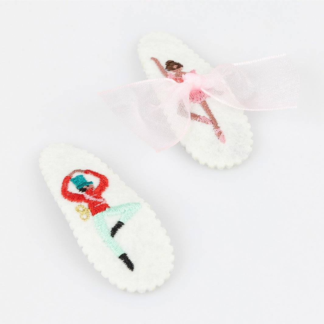 Pair of white slippers with colorful designs on a light gray background