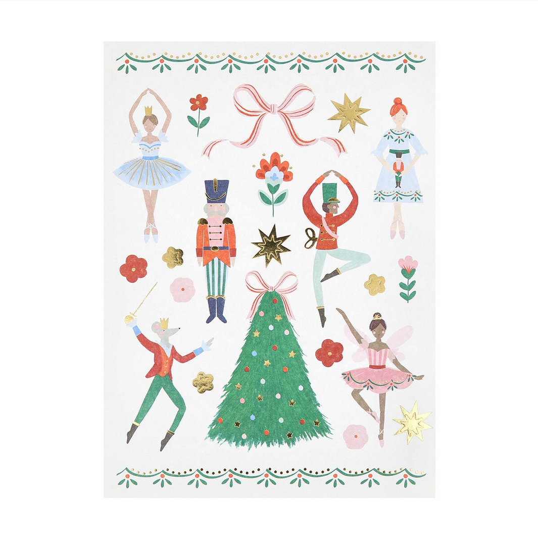 Decorative paper with Christmas-themed illustrations including dancers, a tree, and ornaments on a white background.