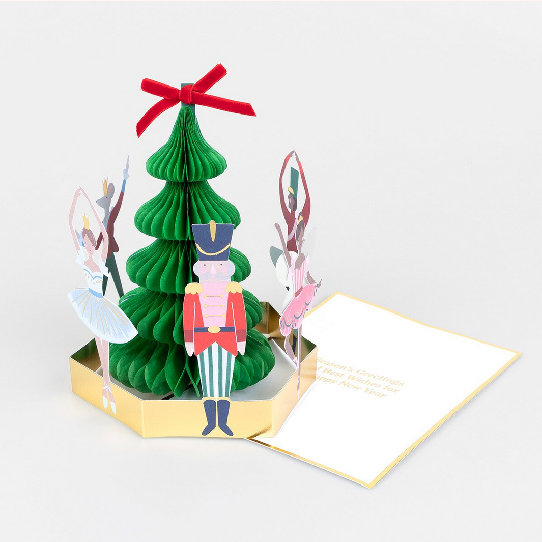 3D pop-up card with a green Christmas tree and nutcracker design on a white background