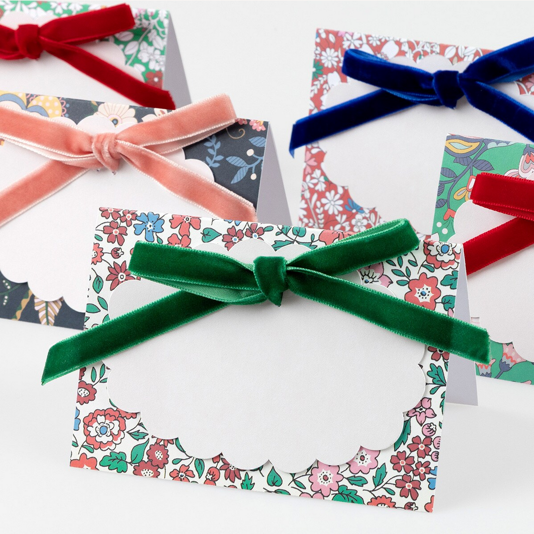 Floral-patterned cards with colorful ribbons on a white background
