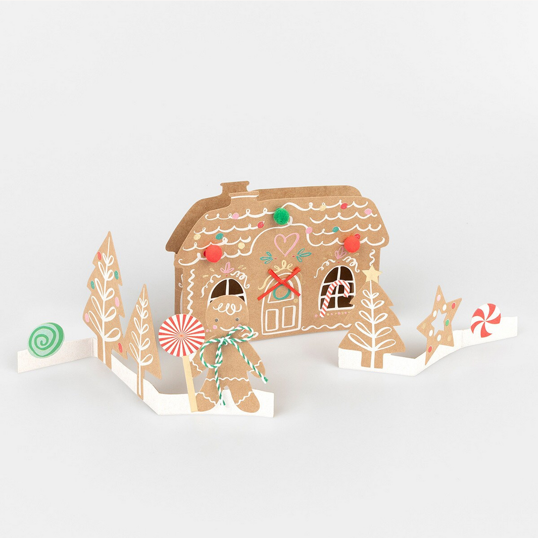Gingerbread house card with decorative elements on a white background