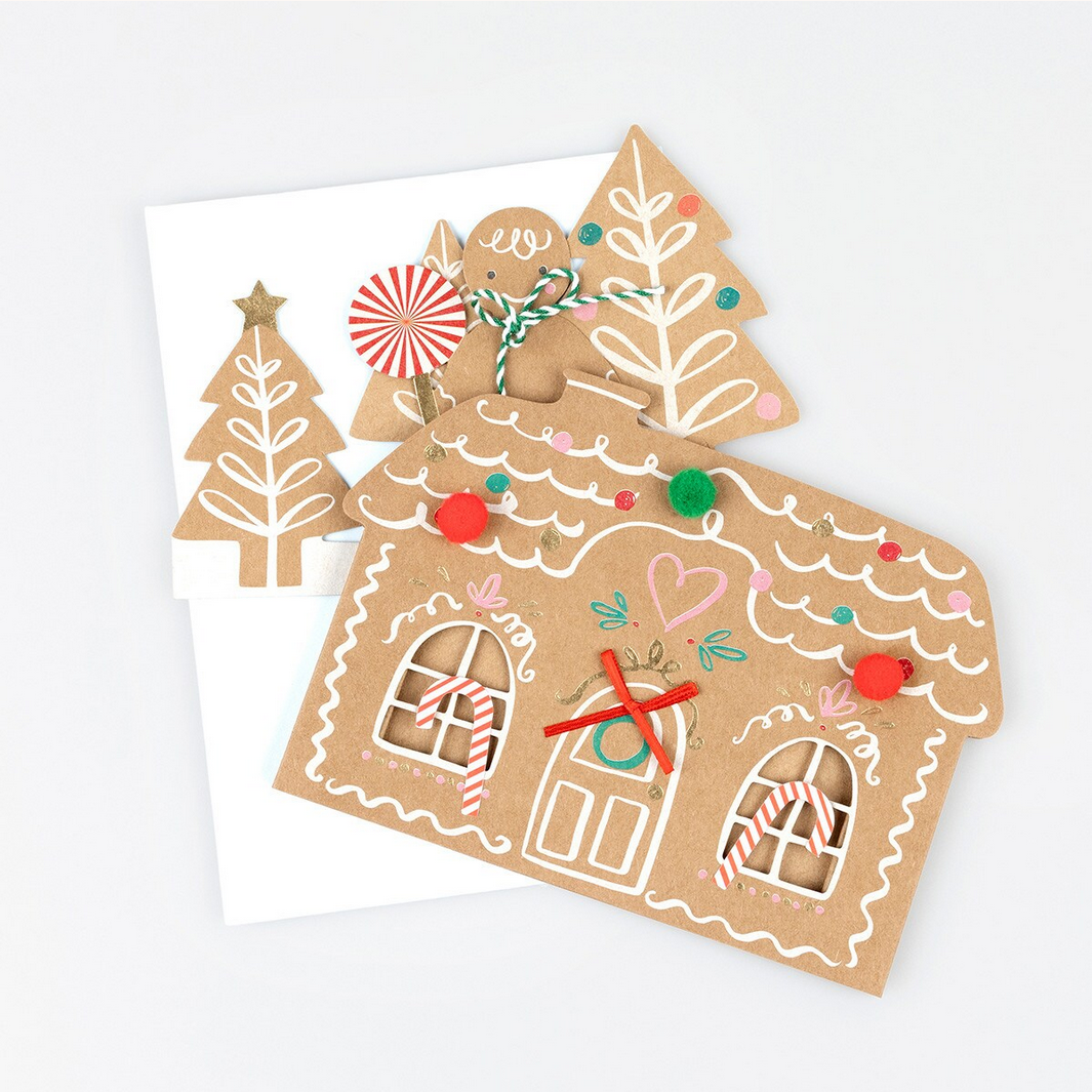 Gingerbread house card with decorative elements on a white background