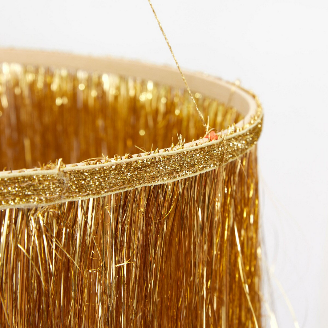 Close-up of a gold tinsel trim on a white background